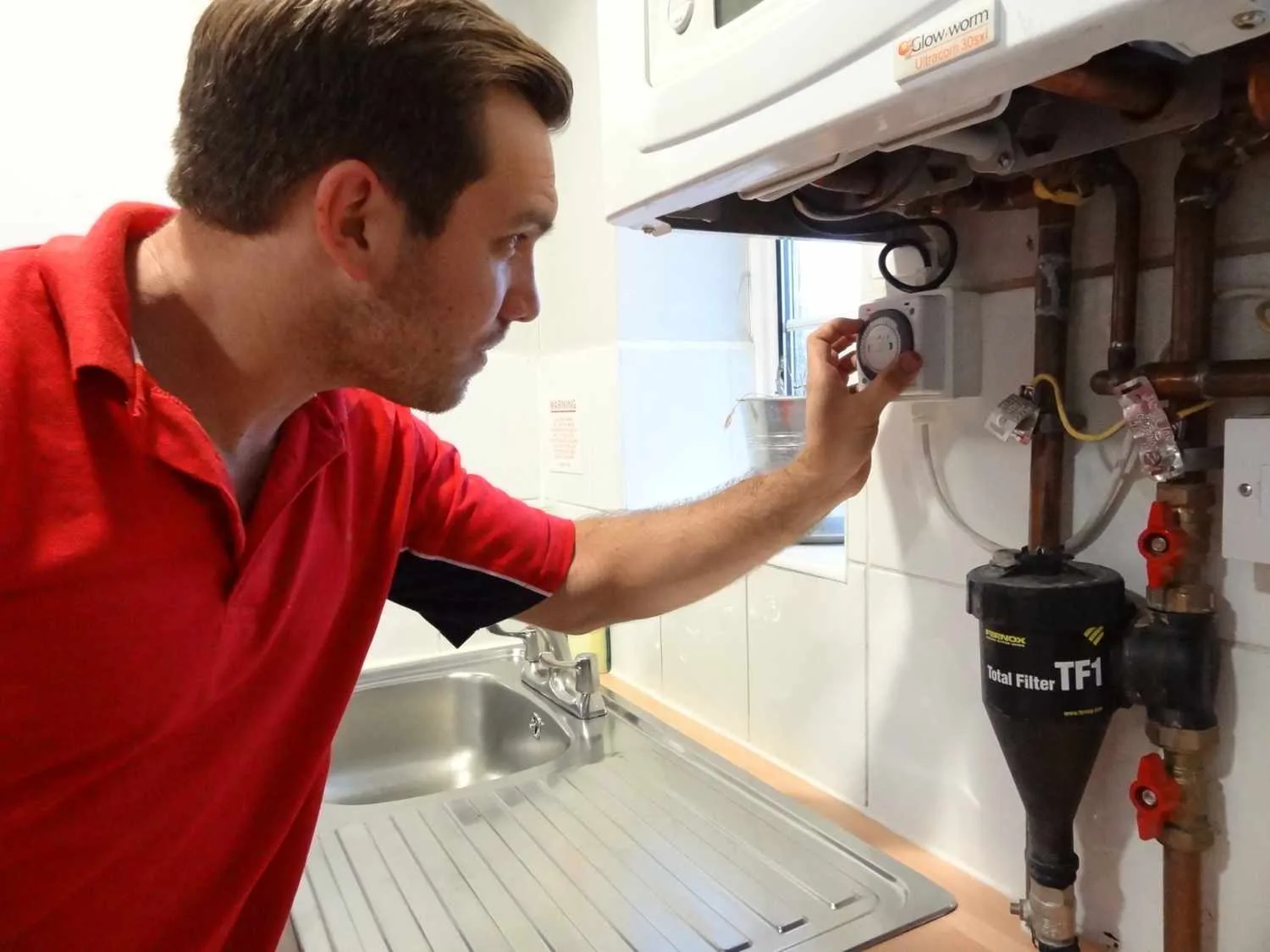 Loughton Plumbers 247 boiler repair engineer working on a boiler in Loughton